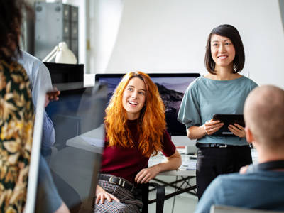 Corporate Professionals Smiling In A Meeting TN